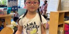 A child posing with her new glasses. // Photo courtesy of KenCrest